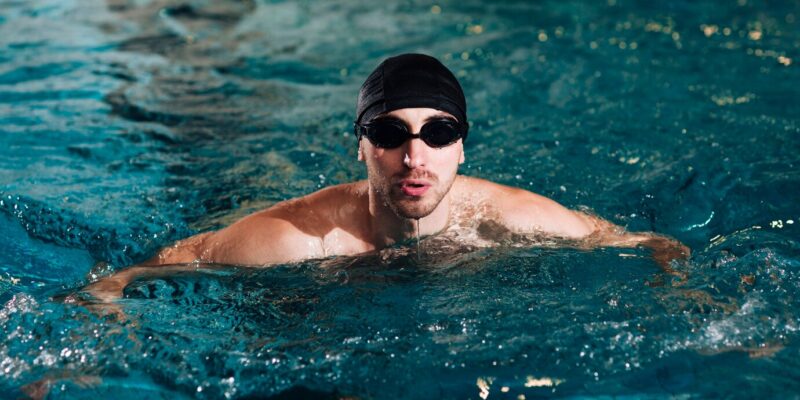 high-angle-male-swimmer-practice-basin_23-2148357015